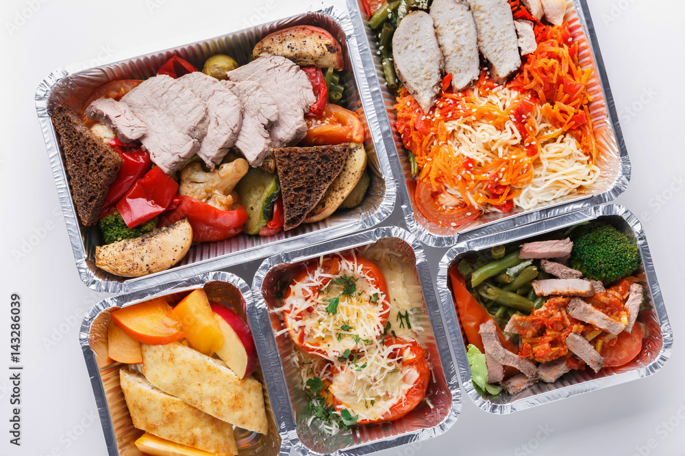 Healthy food take away in boxes, top view at wood