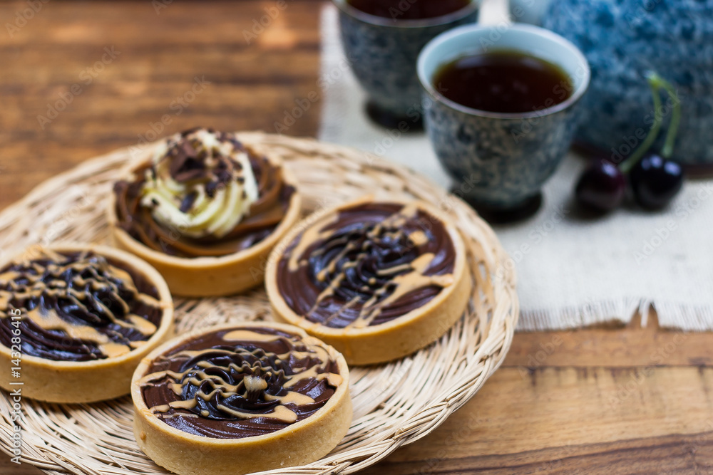 tartlets, basket cakes, sweet, tea on the wodden table tartlets, basket cakes, sweet, tea on the wodden table