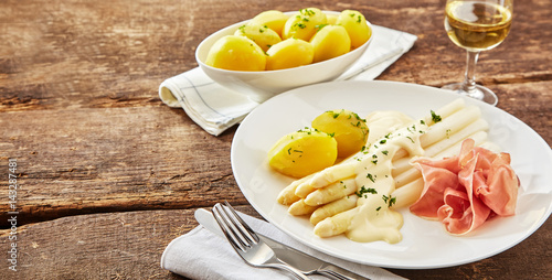 Plate of cured ham with white asparagus tips