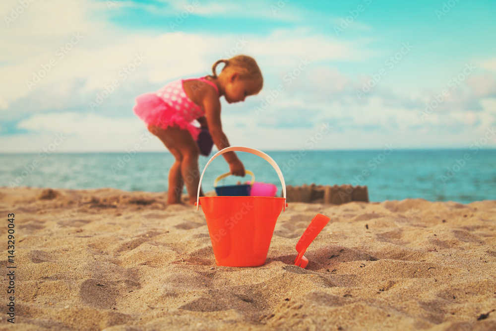 kids toys and little girl playing on the beach kids toys and little girl playing on the beach