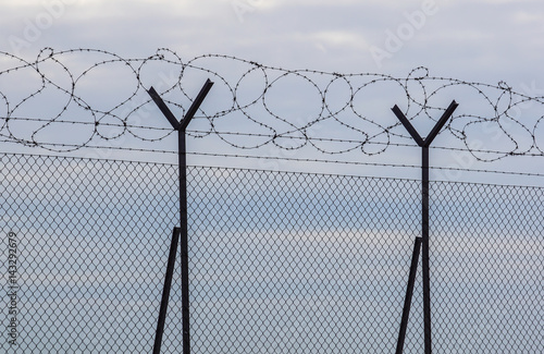 Razor Barbed wire against a blue sky, closeup