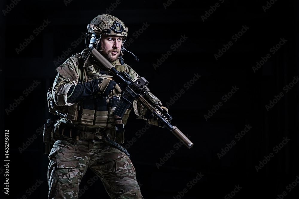 SWAT officer with rifle/Officer with bulletproof vest and rifle in hands on dark background SWAT officer with rifle/Officer with bulletproof vest and rifle in hands on dark background