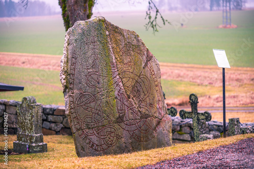 Skanela, Sweden - April 1, 2017: Viking runestone in Skanela Church, Sweden photo