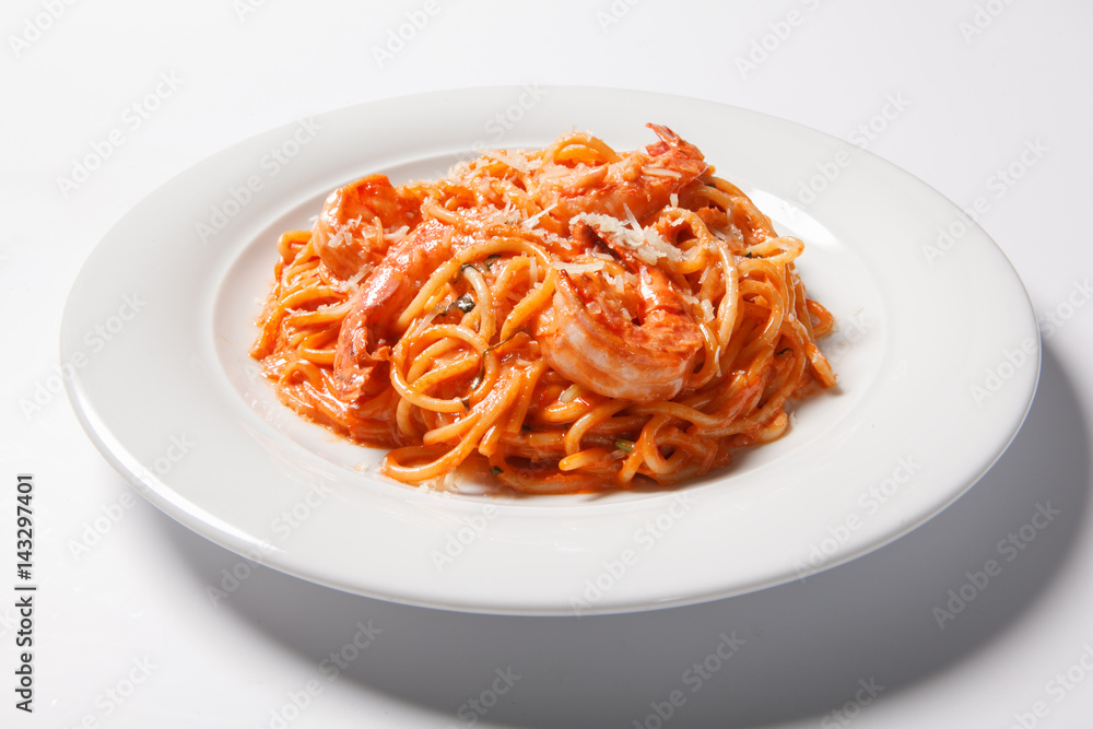 Delicious pasta spaghetti with shrimps, tomato sauce, cheese on a white plate Delicious pasta spaghetti with shrimps, tomato sauce, cheese on a white plate