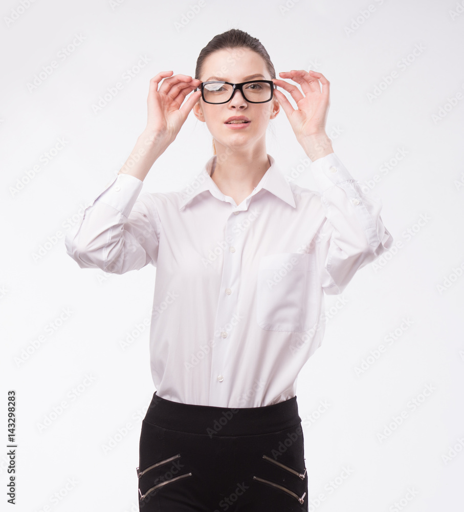Young happy woman showing presentation, pointing on placard over gray background Young happy woman showing presentation, pointing on placard over gray background
