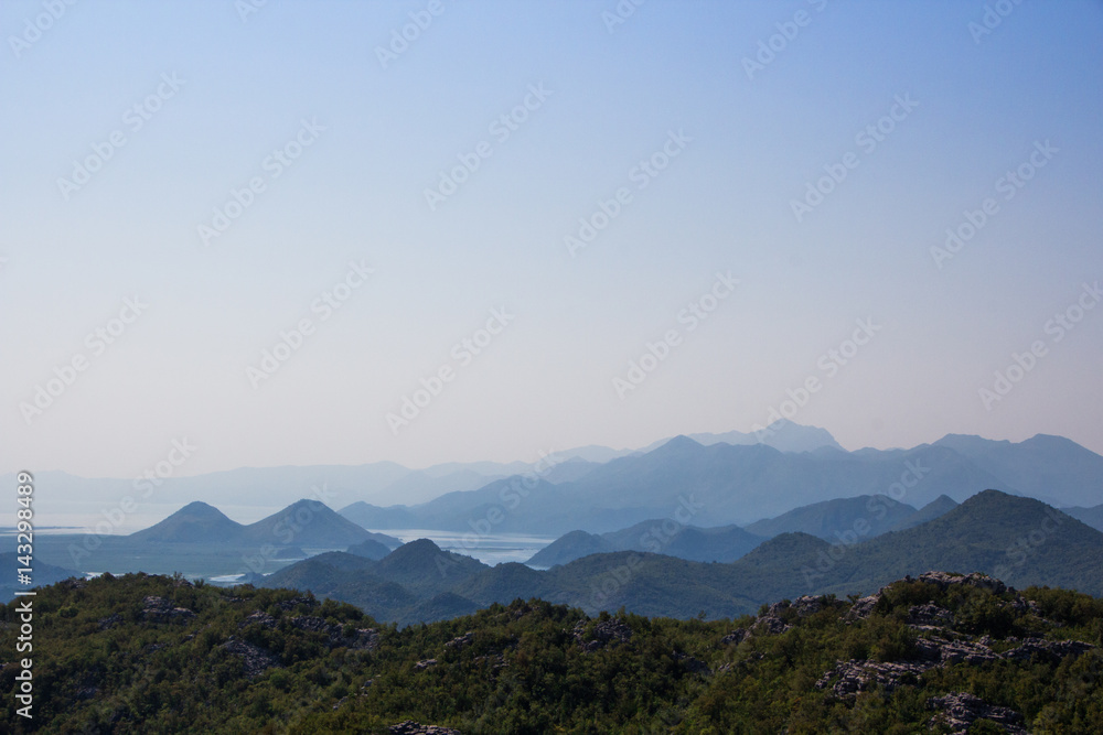 The mountainous landscape: the mountains, the sky, mountain lakes, heavenly gradient. Silhouette of the mountains against the sky.