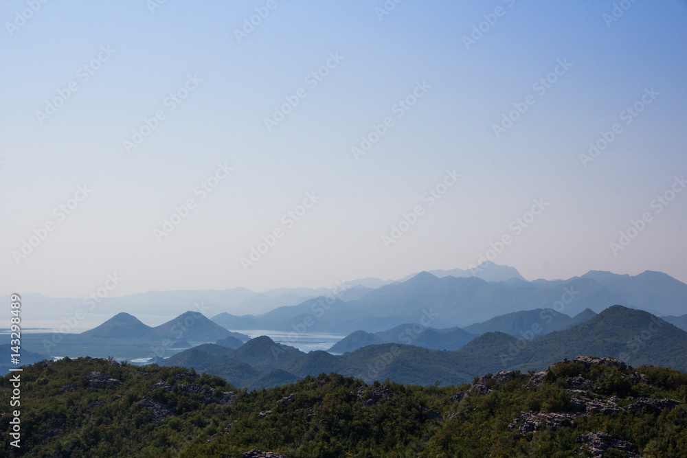 Fototapeta premium The mountainous landscape: the mountains, the sky, mountain lakes, heavenly gradient. Silhouette of the mountains against the sky.