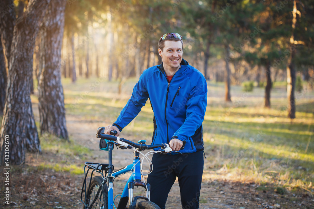 man cyclist rides in the forest on a mountain bike. man cyclist rides in the forest on a mountain bike.
