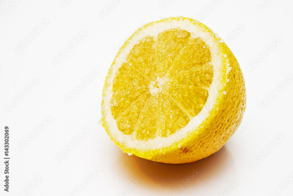 Yellow half of lemon with sugar on the white background