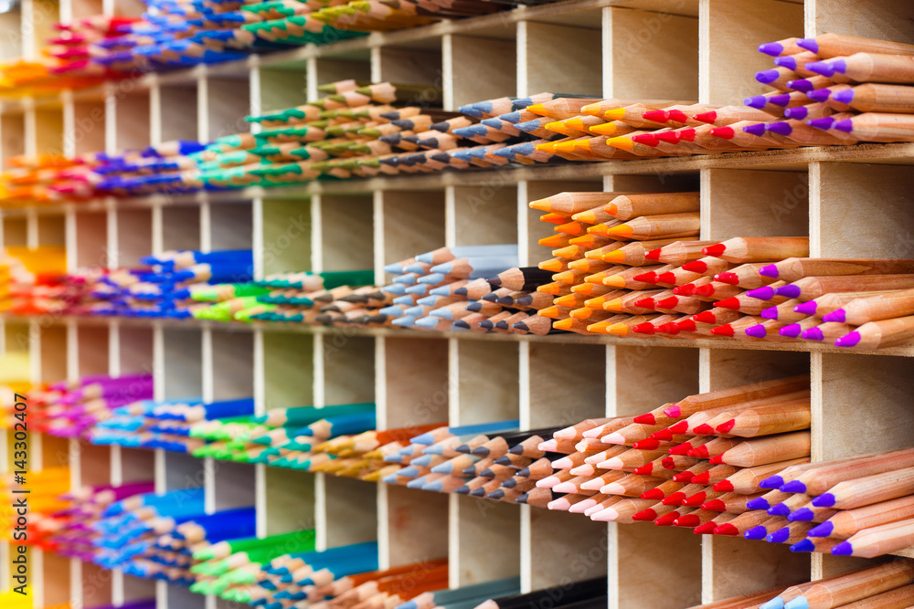 Multicolored pastel pencils in art store closeup