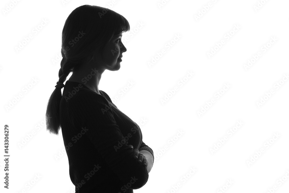 silhouetteof a female with her arms folded over her chest