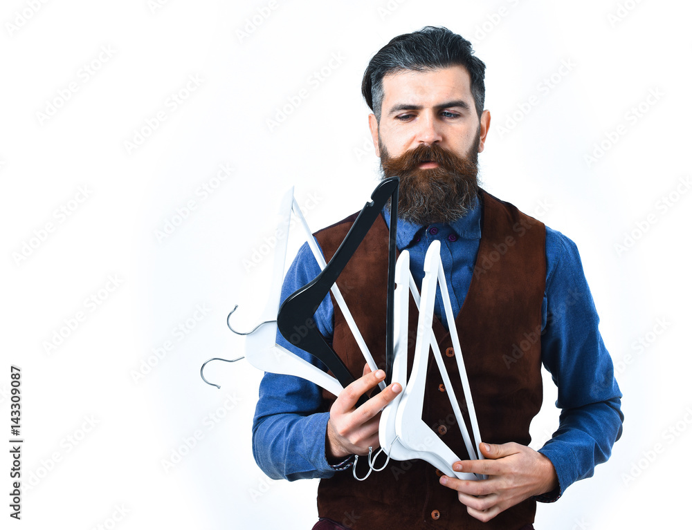 bearded man holding clothes racks with serious face bearded man holding clothes racks with serious face