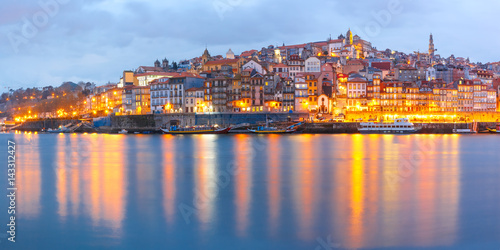 Ribeira and Old town of Porto with mirror reflections in the Douro River during evening blue hour  Portugal  Portugal.
