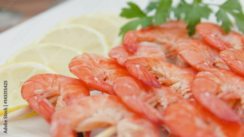 Close-up of shrimp on a white plate with lemon and parsley Close-up of shrimp on a white plate with lemon and parsley