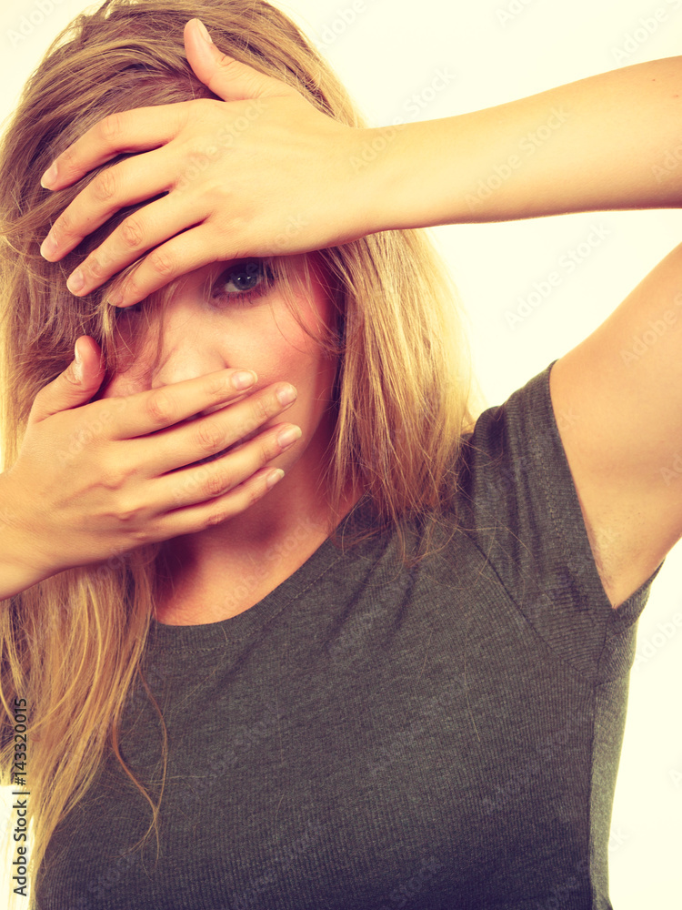 Obraz premium Ashamed embarrassed blonde woman with hands on face