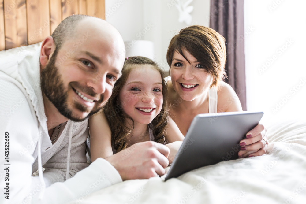 Mother father and her child with digital tablet relaxing at home Mother father and her child with digital tablet relaxing at home