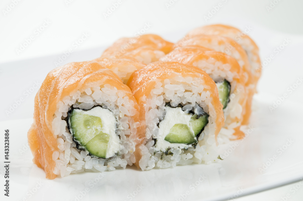 Sushi rolls with salmon and cucumbers in the middle Sushi rolls with salmon and cucumbers in the middle