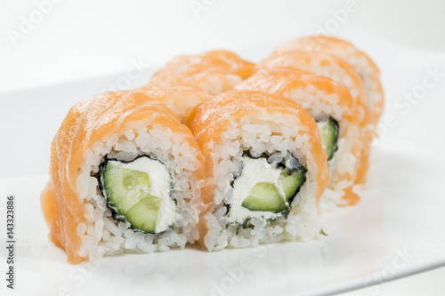 Sushi rolls with salmon and cucumbers in the middle