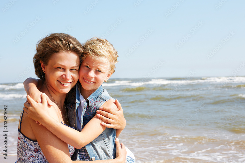  Happy woman and little girl  having fun over blue sky background