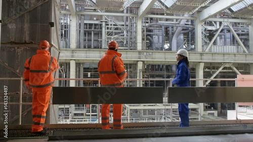  Time lapse of busy team of engineers working together inside power station photo