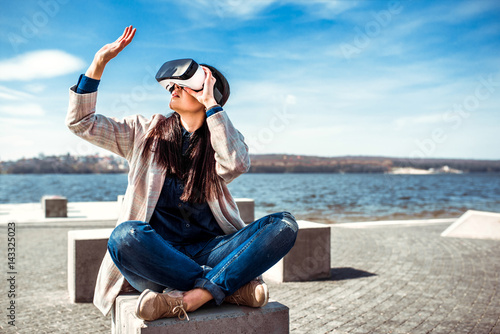 Pretty girl outdoor enjoying virtual reality glasses © bedya