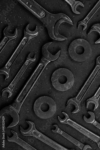 Set of black & white repair tools on black background