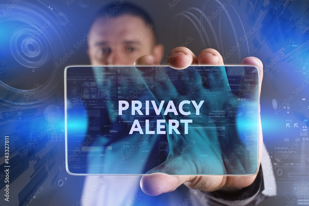 Fototapeta premium Business, Technology, Internet and network concept. Young businessman working on a virtual screen of the future and sees the inscription: Privacy alert