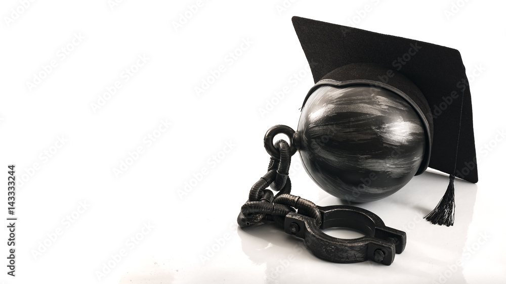 Student debt concept with ball and chain wearing graduation cap