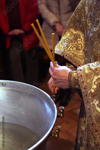the Orthodox priest during the baptismal ceremony Fototapeta