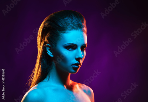 Portrait of a beautiful  seductive and young girl. Mixed and fashionable lightning effect.