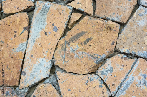 Closeup wall covered in pieces of stone background photo