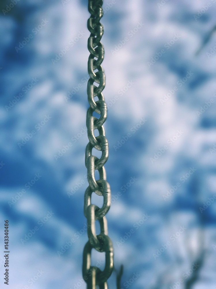 Steel Chain against dramatic cloudy sky Steel Chain against dramatic cloudy sky