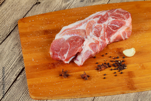 Raw pork chop and steaks for barbecue photo