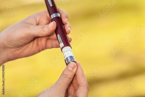 Woman hands using lancet.