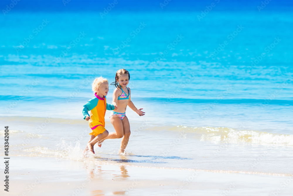 Kids run and play on tropical beach