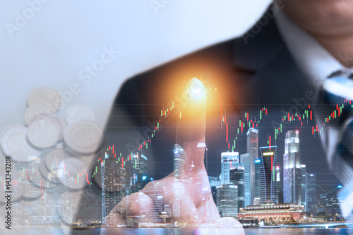 Financial trading stock concept with businessman touching hologram