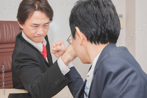 Two Businessman Competing In Arm Wrestling