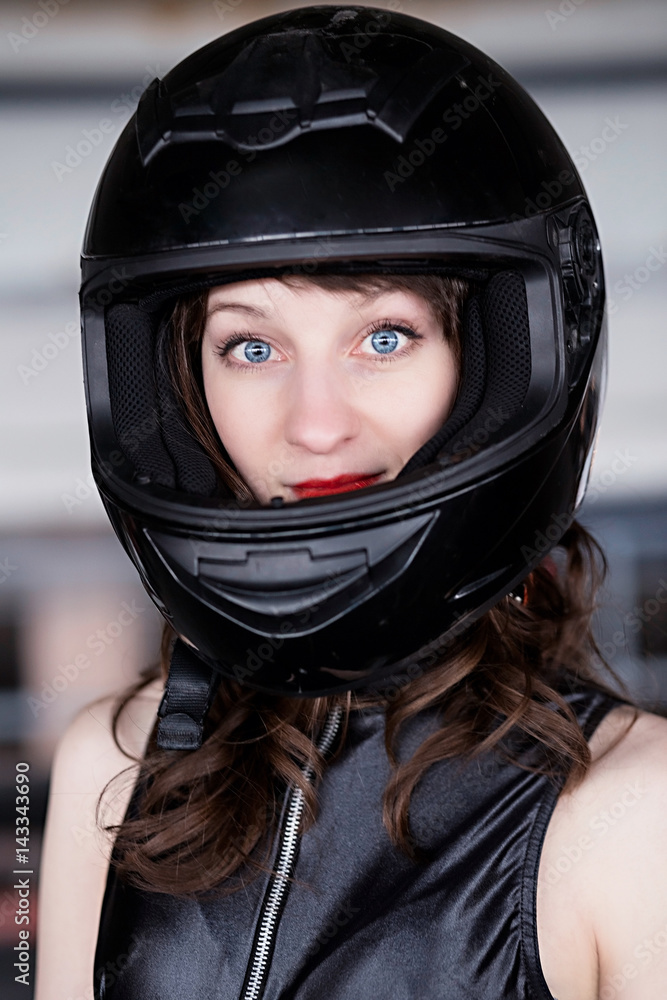 Young Vibrant Intense Girl in black Face Motorcycle Racing Helmet Young Vibrant Intense Girl in black Face Motorcycle Racing Helmet