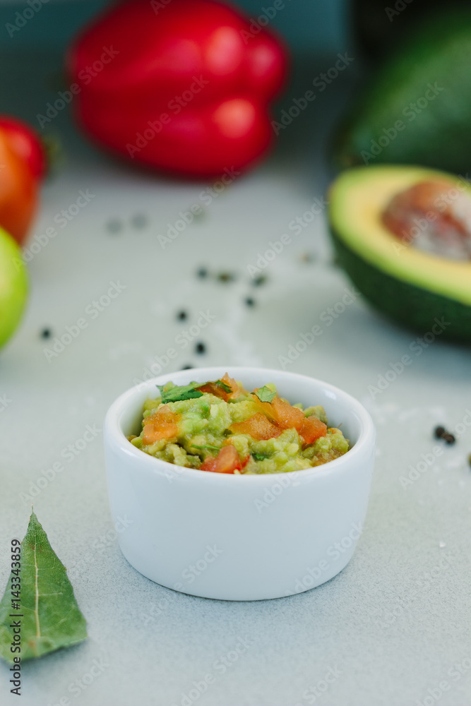 Traditional mexican avocado - vegetarian dip surrounded by its ingredients. Traditional mexican avocado - vegetarian dip surrounded by its ingredients.