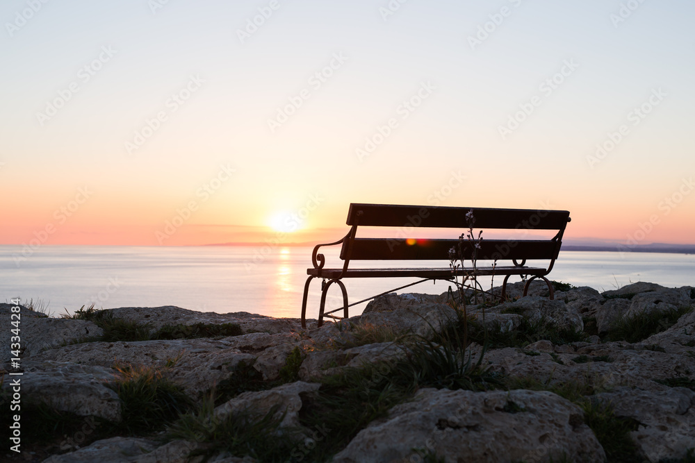 Back view of bench near sea. Sea shore bench.