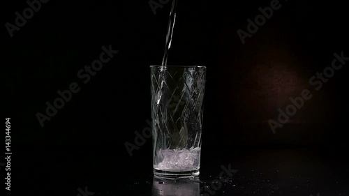 soda is poures into a glass photo