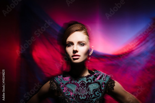 Portrait of a beautiful, seductive and young girl. Mixed and fashionable lightning effect. © Acronym