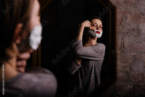 Peculiar girl shaving like a man