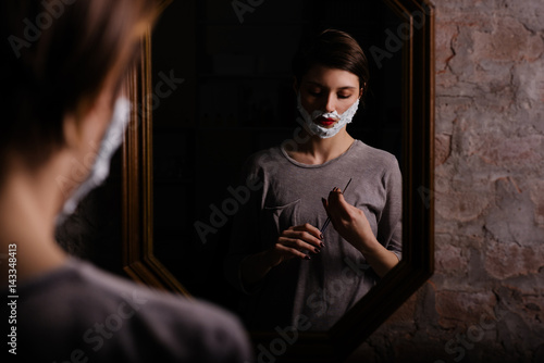Female attempting to shave with a straight razor