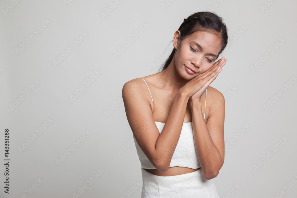 Beautiful young Asian woman with sleeping gesture. Beautiful young Asian woman with sleeping gesture.