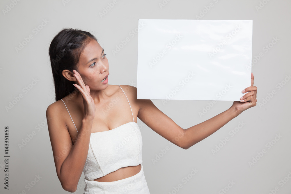 Young Asian woman surprise with white blank sign. Young Asian woman surprise with white blank sign.