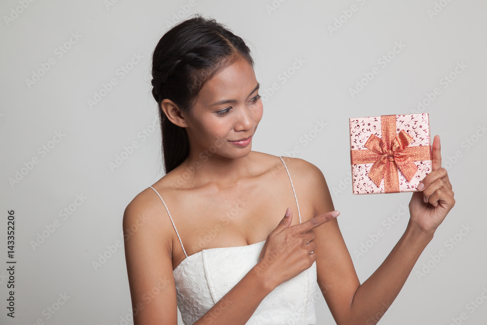 Young Asian woman with a gift box. Young Asian woman with a gift box.