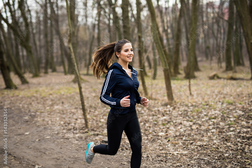 Young woman running outdoors on a lovely sunny autumn. Health concept Young woman running outdoors on a lovely sunny autumn. Health concept