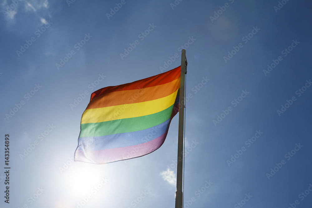 Rainbow flag on a flagpole Rainbow flag on a flagpole