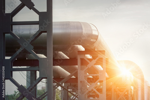 Industrial pipe with gas and oil and water on a sunlight background